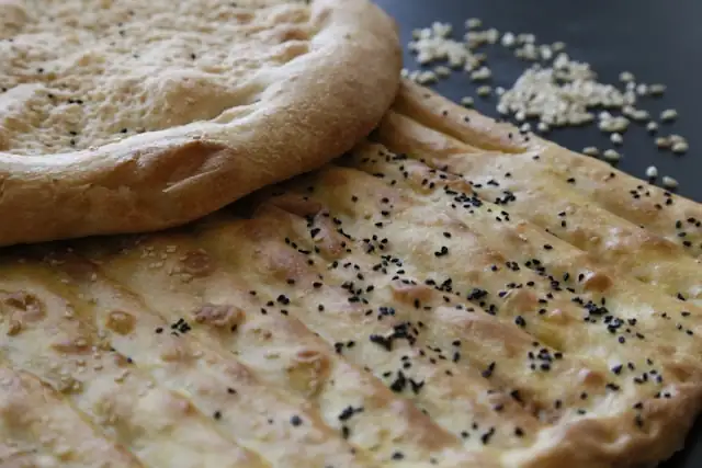 Garlic_Coriander_Naan_with_Seeds_Flavorful_Bread_Delicious_Indian_Cuisine_Naan_Variety_Nutritious_Savory_Baked_Good_Seeds_Infusion_Aromatic_Touch_Healthy_Bread_Alternative_Wholesome_Snacking_Garlic_Coriander_Aroma_Satisfying_Naan_Bite_Homemade_Ayurvedic_Food_Ayurveda